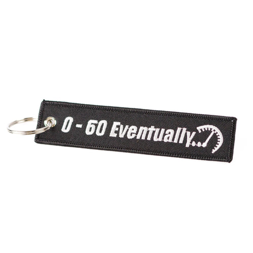 Black keychain with white text '0-60 Eventually' and a graphic