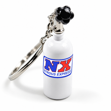 A novelty keychain shaped like a white nitrous car bottle with a black paw-shaped cap, attached to a silver metal ring. The bottle features a blue and red 'NX Nitrous Express' logo on the front.