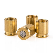 Four brass bullet casings arranged on a clean white background, with one casing lying on its side showing the center and rim details.