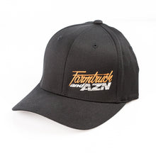 A black Flexfit semi-curved bill cap with 'Farmtruck and AZN' logo embroidered in orange and white on the front.