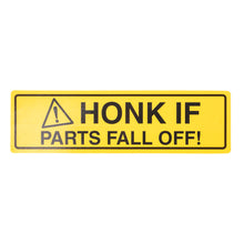 A rectangular yellow warning sign with black text reading 'HONK IF PARTS FALL OFF!' and a hazard triangle icon, shown on a plain white background.
