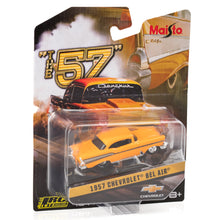 A 1957 Chevrolet Bel Air diecast model, colored in yellow and black, packaged in a cardboard hanger with a clear display, labeled as 'The 57' by Maisto.