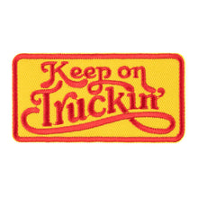 Embroidered patch with 'Keep on Truckin'' text on a yellow background