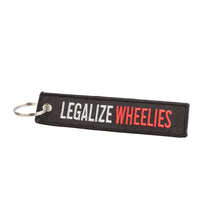 Keychain with 'LEGALIZE WHEELIES' text on a white background