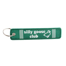 Green keychain with 'silly goose club' text and duck illustration on a white background