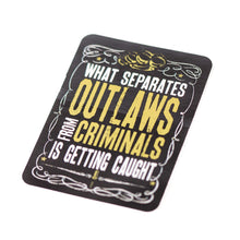 A rectangular sticker with black background and yellow text that reads 'WHAT SEPARATES OUTLAWS FROM CRIMINALS IS GETTING CAUGHT'. As seen on Street Outlaws Discovery Channel
