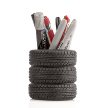 Pencil holder made from stacked tire slices with markers inside on a white background