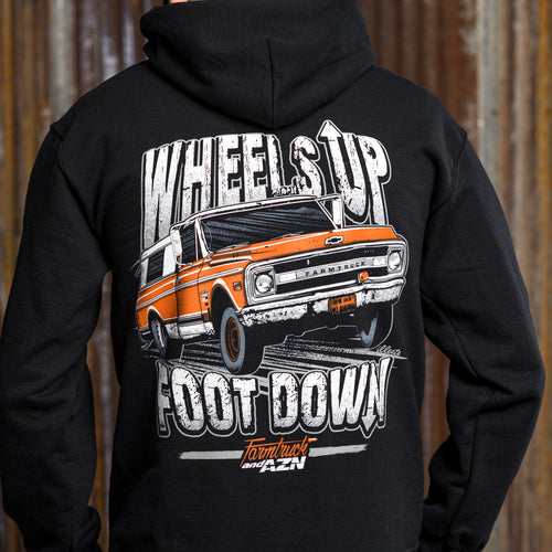 A black hoodie with a graphic print of a classic truck and the phrases 'Wheels Up' and 'Foot Down'.