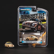 A 1/64 scale diecast model of a 1966 VW Dung Beetle, packaged in a clear plastic figure stand with a 'Dung Beetle' banner, on a black background.